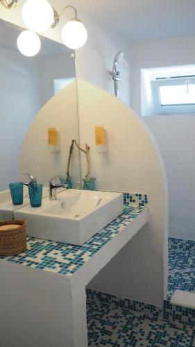 a bathroom with a white tub and a sink at Casa de la Mare in Vama Veche