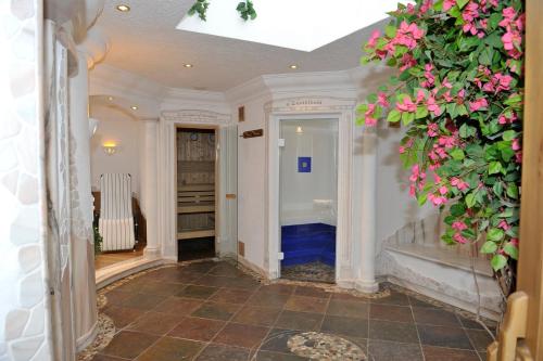 a hallway with a staircase with pink flowers at Lettmaierhof in Haus im Ennstal