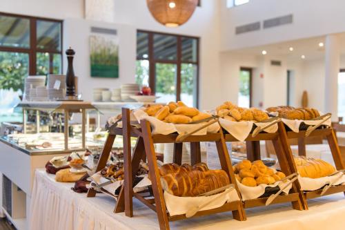 a display of breads and pastries on a table at Tisza Balneum Hotel in Tiszafüred