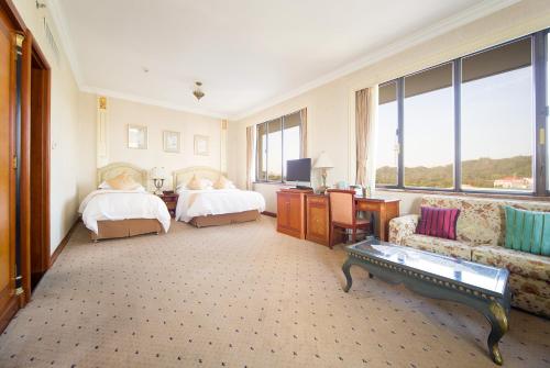 Katil atau katil-katil dalam bilik di Huiquan Dynasty Hotel Qingdao