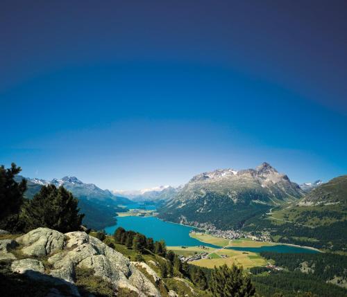 a view of a lake in the mountains at Nira Alpina in Silvaplana