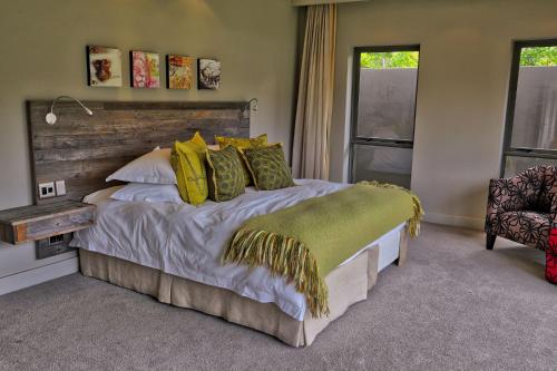 a bedroom with a large bed with yellow pillows at Blue Horizon in Knysna