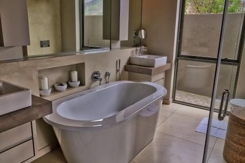 a bathroom with a large tub and a shower at Blue Horizon in Knysna