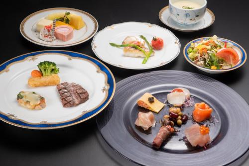 a group of plates of food on a table at Hotel Green Hill Kagoshima in Satsumasendai