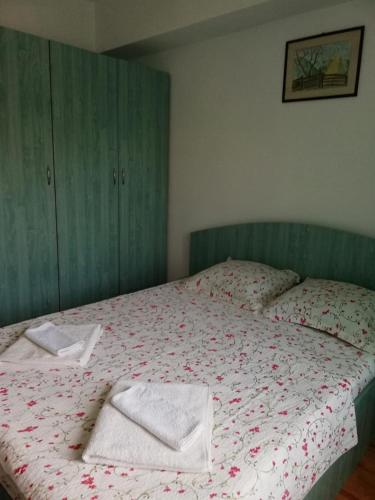 a bedroom with a bed with two towels on it at Vila Didi, Mangalia in Mangalia
