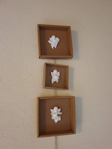 a wall with four brown boxes on it at El Serrat Turisme Rural in Planoles