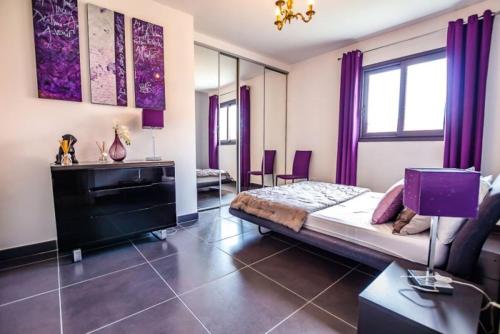 - une chambre avec un lit doté de rideaux violets et d'un piano dans l'établissement APPARTEMENT TERRASSE CITA DI SALI PORTO VECCHIO, à Porto-Vecchio