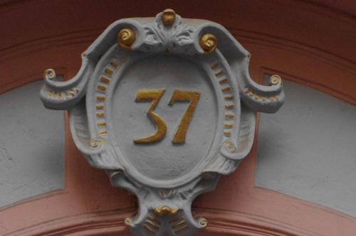 a clock on the side of a building with the number at Boutique Hotel & Bio Wirtshaus Schwarzer Bock in Ansbach