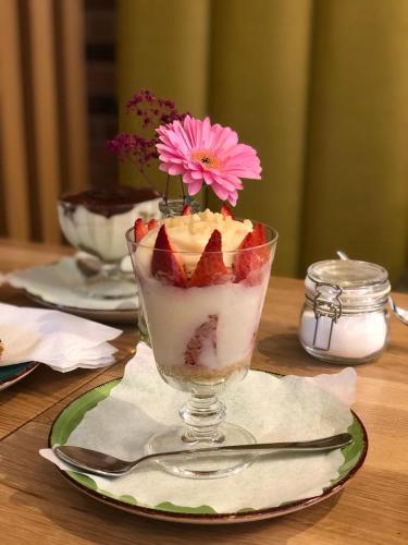 a dessert in a glass on a plate on a table at Bayer's Boardinghouse und Hotel in Munich