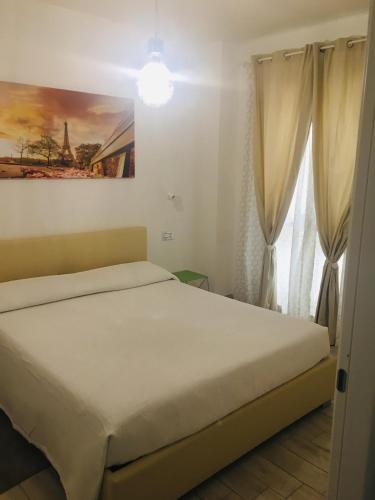 a bedroom with a bed and a window at Residence Le Terrazze in La Maddalena