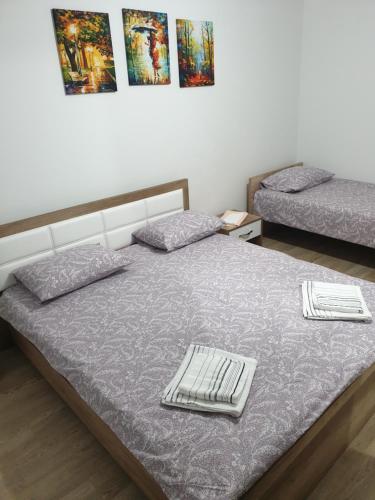 a bedroom with two beds with towels on them at Ivana Apartments in Gevgelija