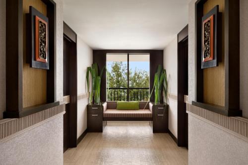 a hallway with a couch and a window at Shangri-La Golden Sands, Penang in Batu Ferringhi