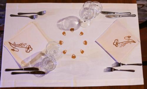 a table with wine glasses andeating utensils on it at Il Palazzo Ridracoli in Bagno di Romagna