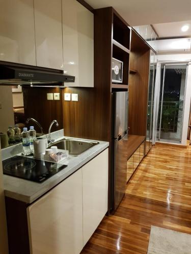 a kitchen with a sink and a refrigerator at M-Town Residence Gading Serpong by J`s Luxury Apartment in Tangerang
