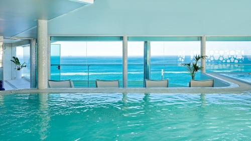 a swimming pool with a view of the ocean at Bull Reina Isabel & SPA in Las Palmas de Gran Canaria