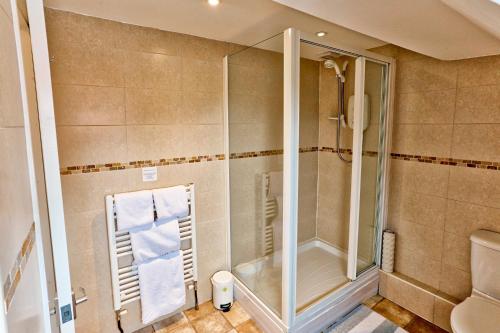 a bathroom with a shower and a toilet at Sefton Court in Llandudno