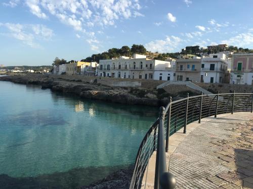 a view of a body of water with buildings at Casa in Salento a pochi passi dal mare in Santa Maria al Bagno