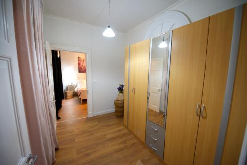 a hallway with a wardrobe and a room with a bedroom at Old Fortress Luxury Suite in Corfu Town