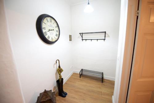 a clock hanging on a wall next to a bench at Old Fortress Luxury Suite in Corfu Town