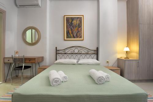 a bedroom with a bed with towels on it at Milonas Studios in Corfu