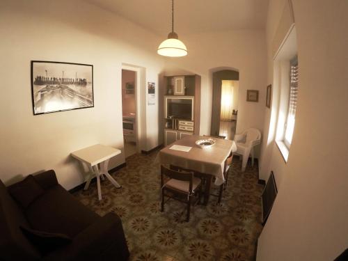 a living room with a table and a dining room at Il Mulino in Favignana