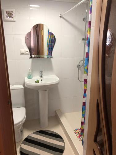 a bathroom with a sink and a toilet and a mirror at квартира in Kislovodsk