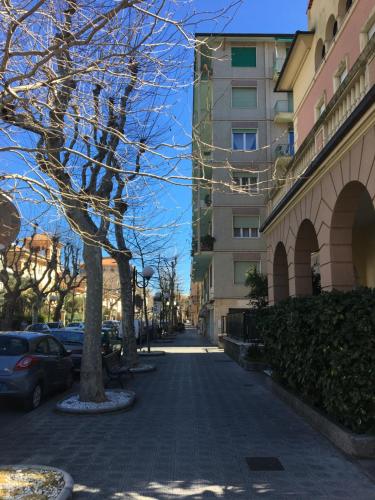 a city street with a tree and buildings at Sapore di sale, sapore di mare in Chiavari