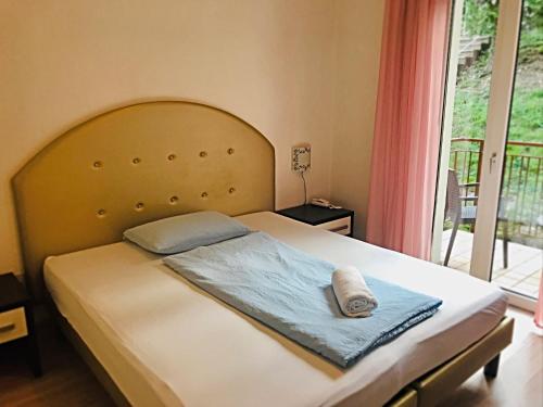 a bedroom with a large bed with a large window at Hotel Villa Carmen in Malcesine