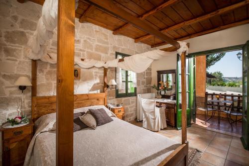 a bedroom with a bed and a stone wall at Enagron Ecotourism Village in Axós