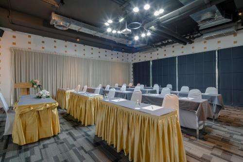 a banquet hall with tables and chairs in a room at DARA Hotel - SHA Plus in Phuket Town