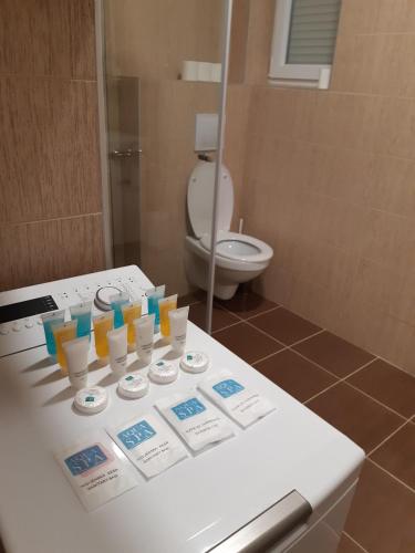 a white counter in a bathroom with a toilet at Kuća BADNJAR Guča in Guča