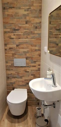 a bathroom with a white sink and a toilet at Casa da Mouraria in Faro