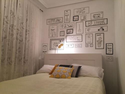 a bedroom with a bed and pictures on the wall at El Quinto Pino in Santibáñez del Val