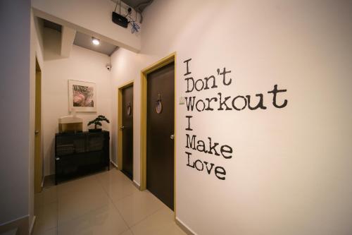 a hallway with a wall with writing on it at The Best Hotel in Bayan Lepas - THE LOV PENANG in Bayan Lepas