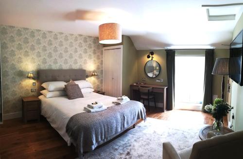 
a bedroom with a large bed and a large window at Anglesey Hotel in Gosport
