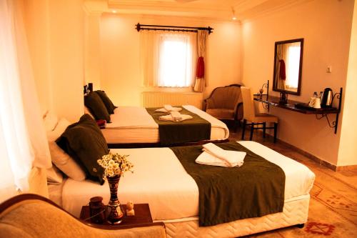 Una cama o camas en una habitación de Kufe Hotel