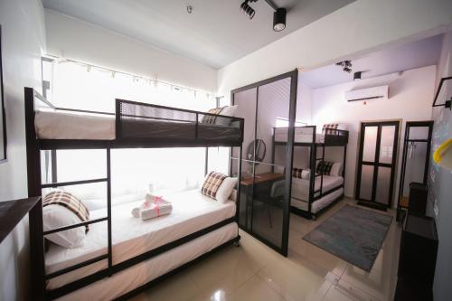a room with two bunk beds in it at The Best Hotel in Bayan Lepas - THE LOV PENANG in Bayan Lepas