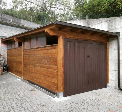 a garage with a brown door on a building at Hotel Reali in Chianciano Terme