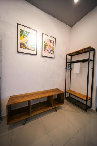a bathroom with a wooden bench and a shelf at The Best Hotel in Bayan Lepas - THE LOV PENANG in Bayan Lepas