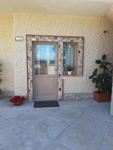 a front door of a house with potted plants at Guest Room Nesea in Pellaro