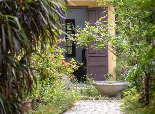 a front door of a house with a stone walkway at Ciel Homestay in Hue