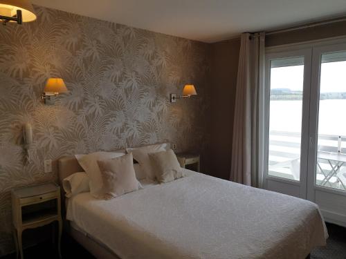 Postel nebo postele na pokoji v ubytování Hotel Restaurant La Caravelle