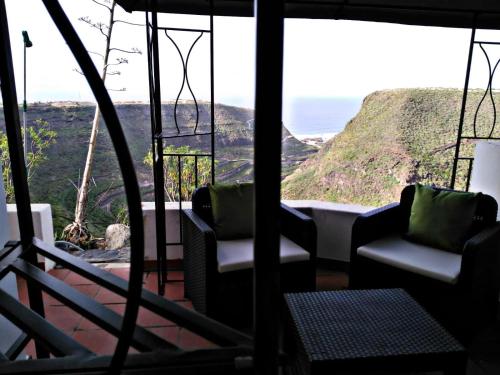 a room with chairs and a view of a mountain at Casa Azuaje in Moya