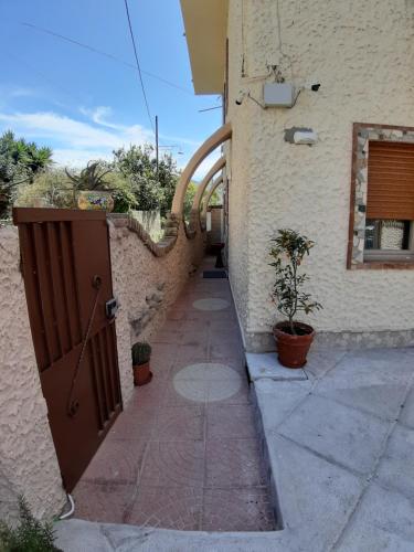 a door to a building with a walkway next to it at Guest Room Nesea in Pellaro