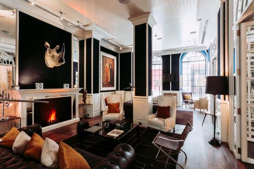 a living room filled with furniture and a fireplace at Only YOU Boutique Hotel Madrid in Madrid