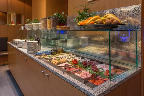 a buffet line with many different types of food at Hotel Museum Budapest in Budapest