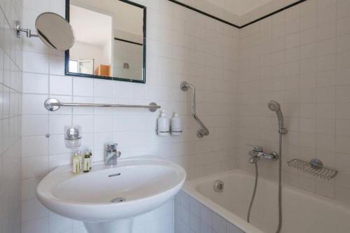 a bathroom with a sink and a tub and a mirror at Orizzonte sul mare in Monterosso al Mare
