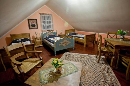 a room with two beds and a table and chairs at Dwór na Wichrowym Wzgórzu in Przybysławice