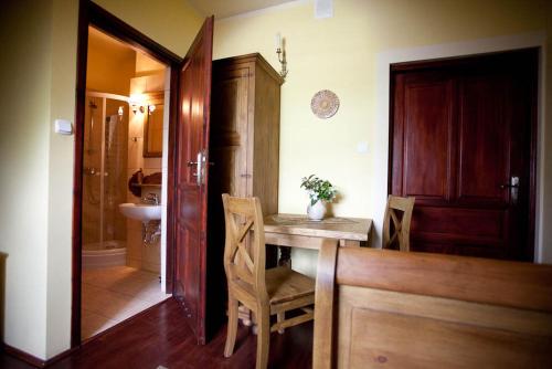 a kitchen with a table and chairs and a bathroom at Dwór na Wichrowym Wzgórzu in Przybysławice