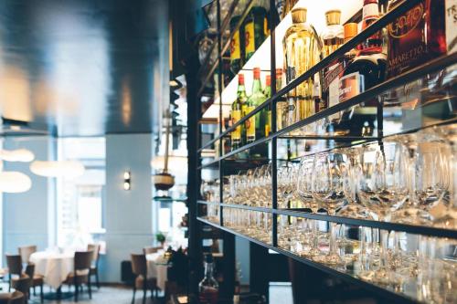 a row of wine glasses on a shelf in a restaurant at Belle de Nuit in Ostend